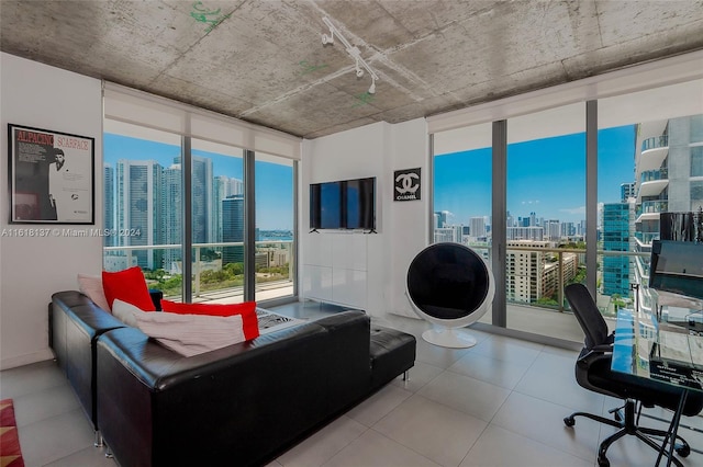 tiled living room featuring expansive windows