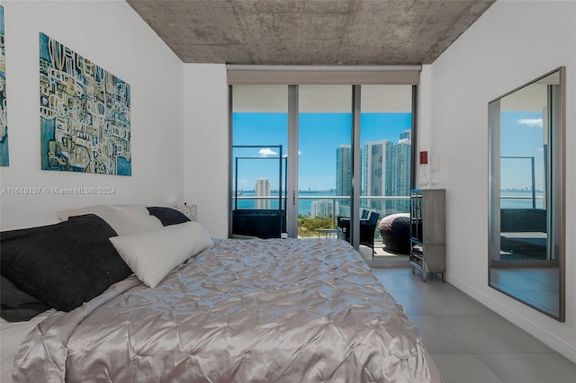 tiled bedroom featuring access to exterior, a water view, and a wall of windows