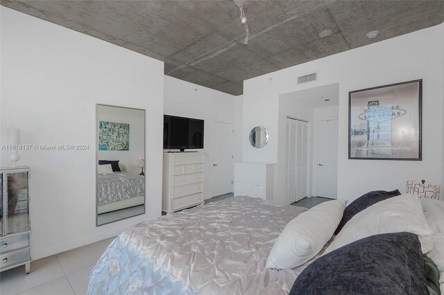 tiled bedroom featuring a closet