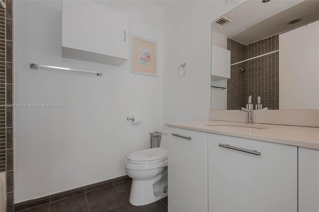 bathroom featuring vanity, toilet, and tile patterned flooring