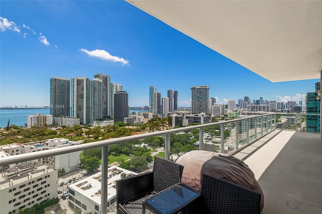 balcony with a view of city and a water view