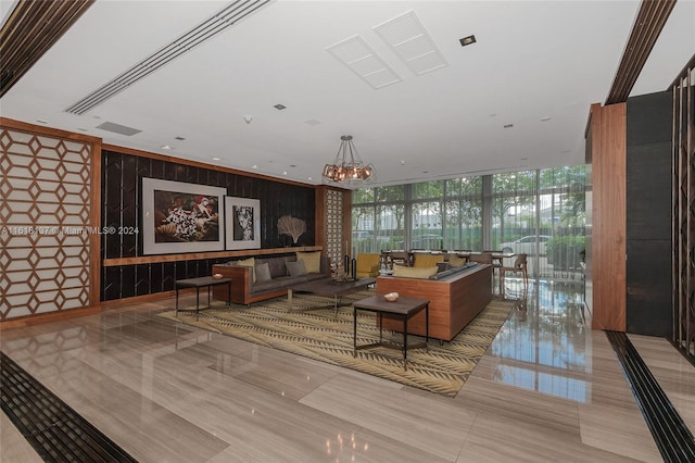 tiled living room with floor to ceiling windows and a notable chandelier