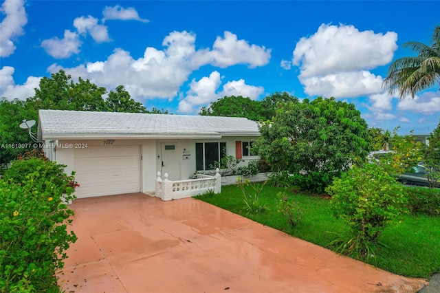 view of front of home featuring a garage and a front lawn