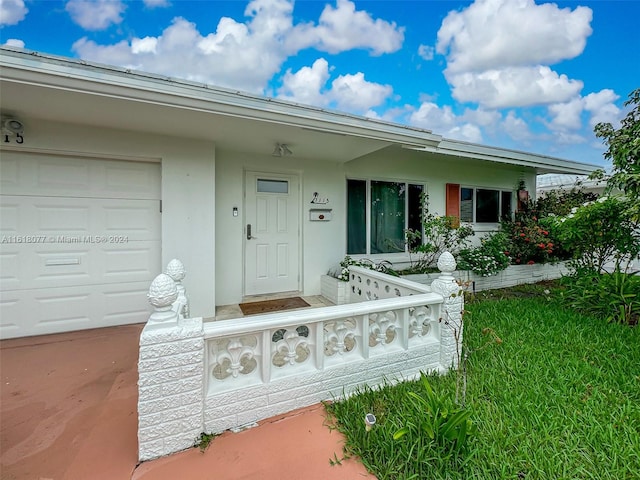 view of exterior entry featuring a garage