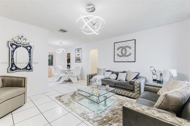 living room featuring an inviting chandelier and light tile patterned floors