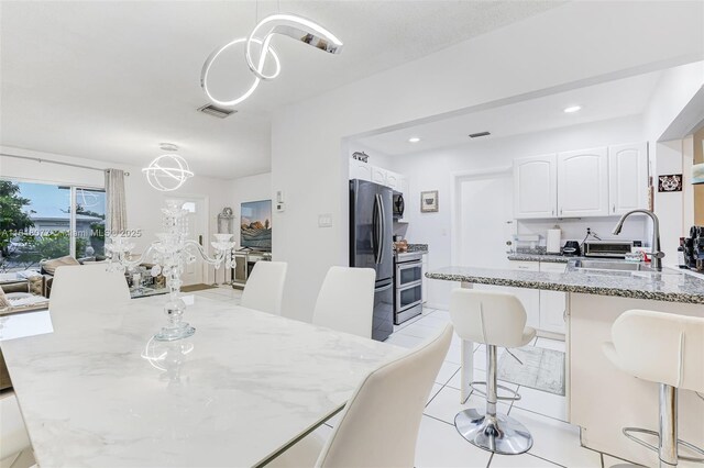 dining room featuring light tile patterned floors and an inviting chandelier