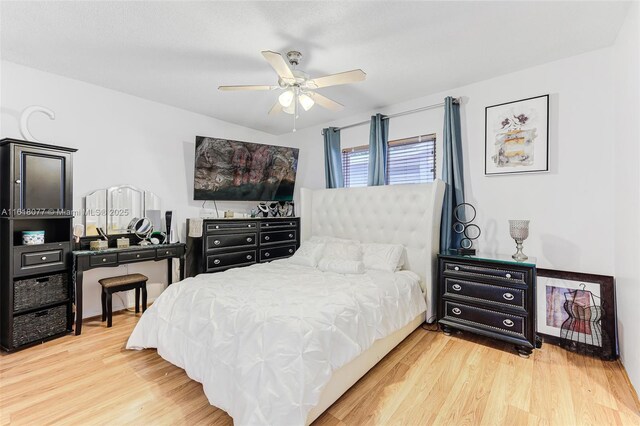 bedroom with hardwood / wood-style floors and ceiling fan