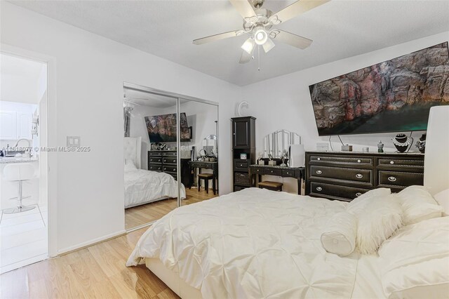 bedroom featuring hardwood / wood-style floors, ceiling fan, and a closet