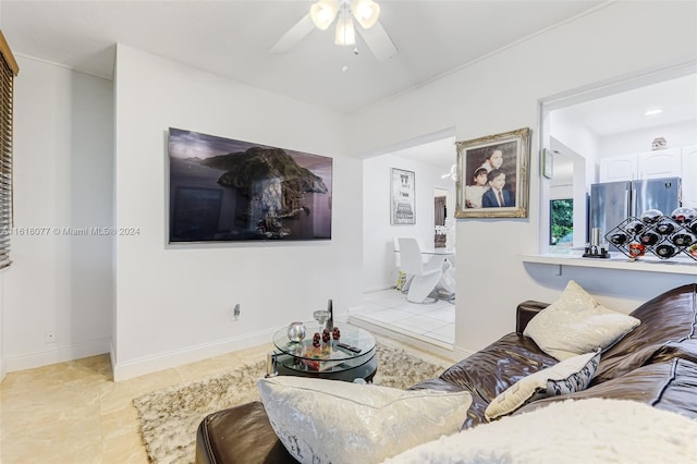 tiled living room with ceiling fan