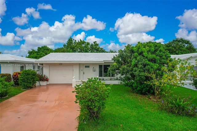 ranch-style house with a garage and a front yard