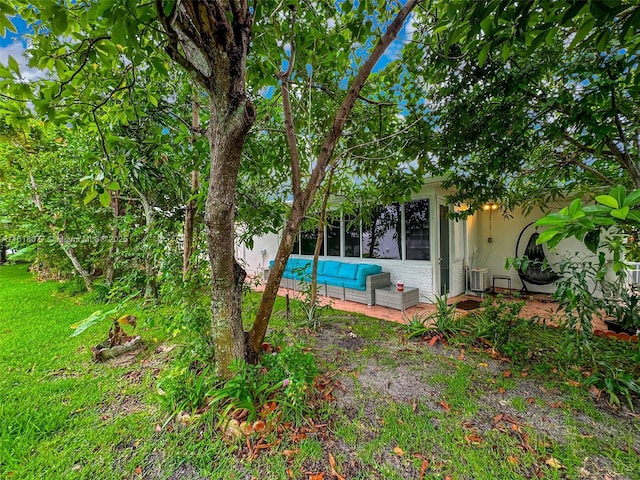 view of yard with an outdoor hangout area, a patio area, and cooling unit