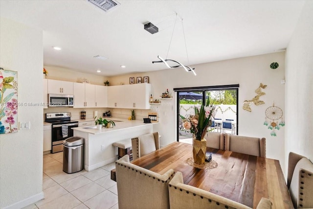 dining room with sink and light tile patterned flooring