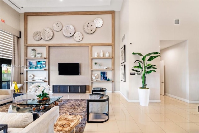 tiled living room featuring a towering ceiling