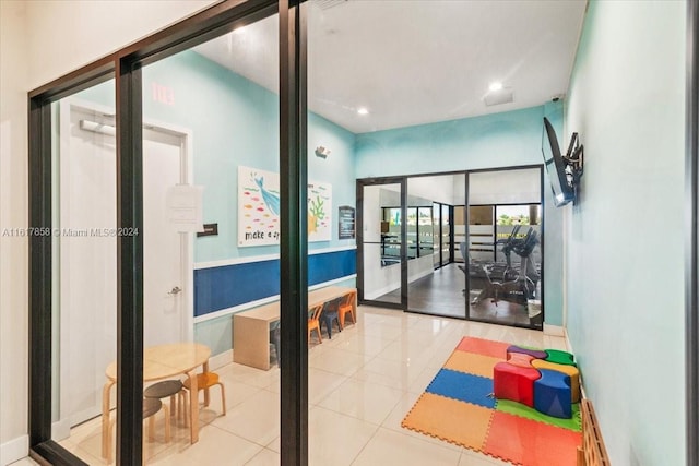 workout room featuring tile patterned floors