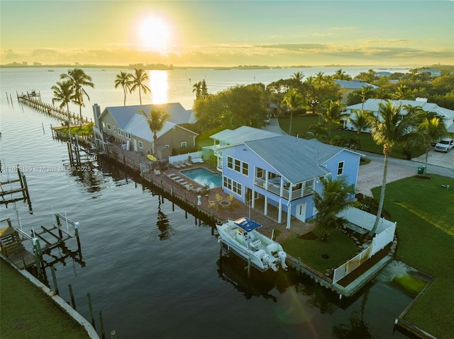 aerial view at dusk with a water view