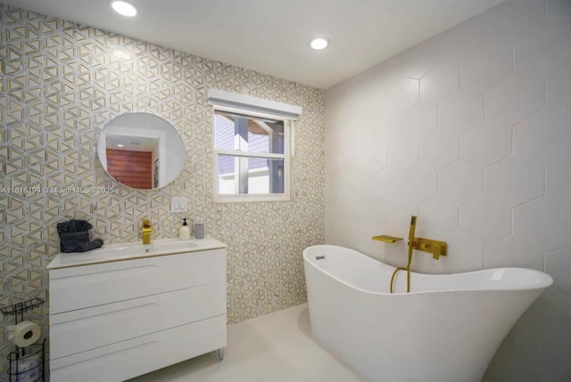 bathroom with a tub to relax in and vanity