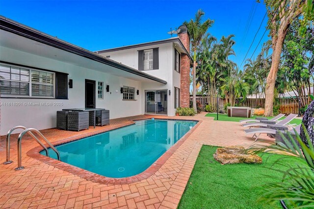 view of pool featuring a patio area and a hot tub