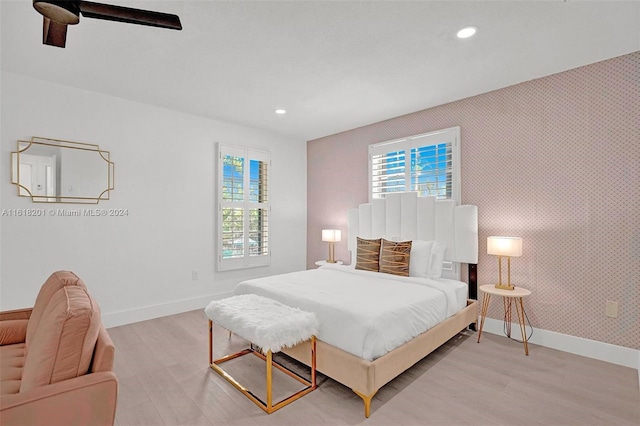 bedroom with light hardwood / wood-style flooring and ceiling fan