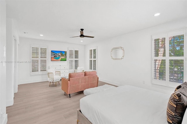 bedroom with ceiling fan and light wood-type flooring