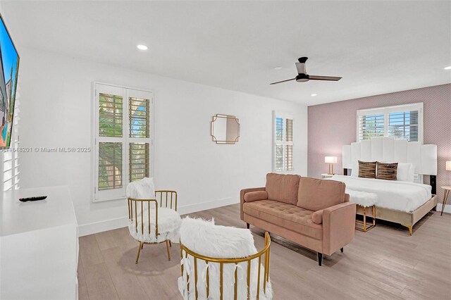 living room with light hardwood / wood-style flooring and ceiling fan