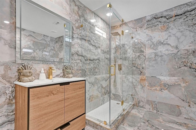 bathroom with vanity, walk in shower, and tile walls