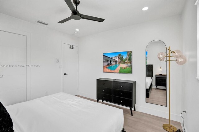 bedroom with light hardwood / wood-style floors and ceiling fan