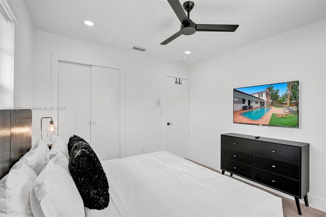 bedroom featuring a closet, ceiling fan, and light wood-type flooring