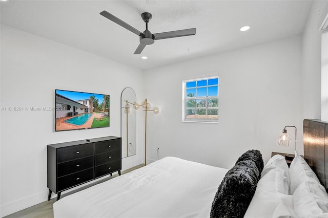 bedroom with ceiling fan and light hardwood / wood-style flooring