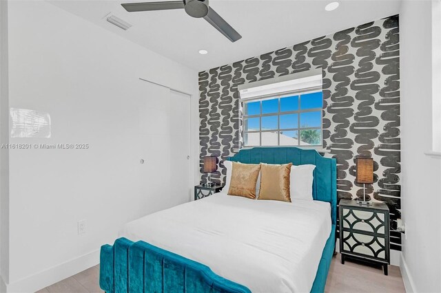 bedroom with light hardwood / wood-style flooring and ceiling fan