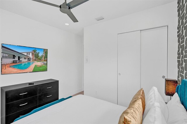 bedroom with ceiling fan and a closet