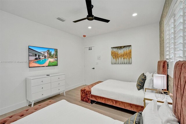 bedroom with light hardwood / wood-style flooring and ceiling fan