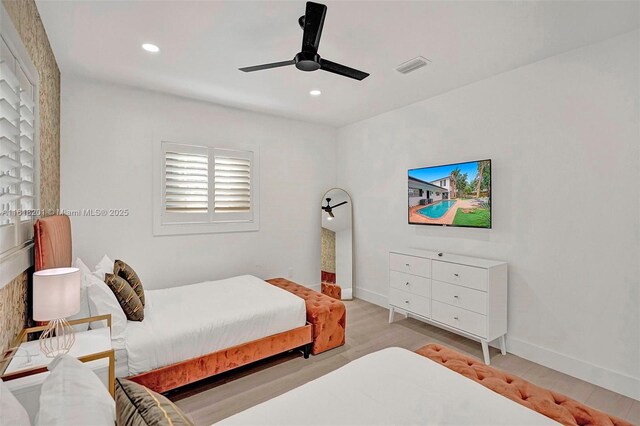 bedroom with ceiling fan and light hardwood / wood-style flooring