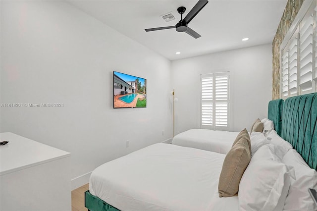 bedroom with ceiling fan and hardwood / wood-style flooring