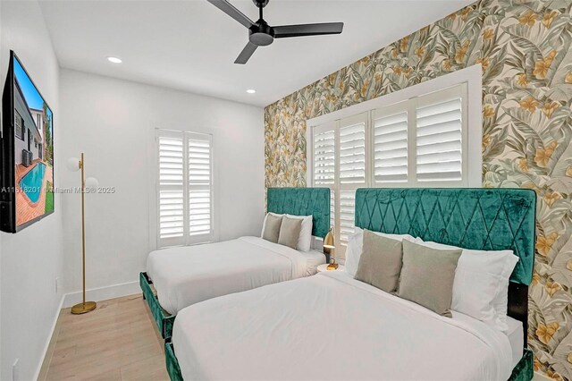 bedroom with ceiling fan and light wood-type flooring