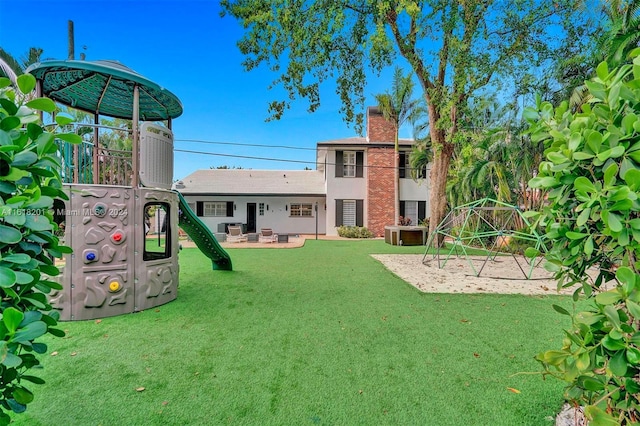 view of yard with a playground and a patio area