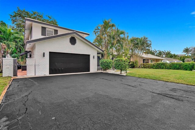 view of front of home with a garage and a front yard