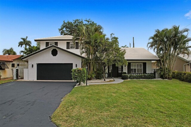 view of front of home with a garage and a front yard