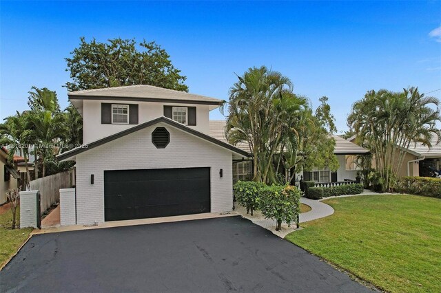 view of front of home featuring a front yard and a garage