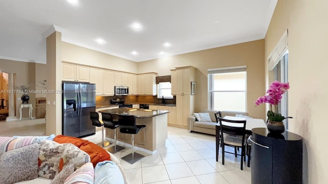 kitchen featuring a kitchen breakfast bar, sink, electric range, fridge with ice dispenser, and a center island