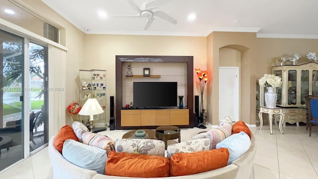 living room with light tile patterned floors, ceiling fan, and ornamental molding