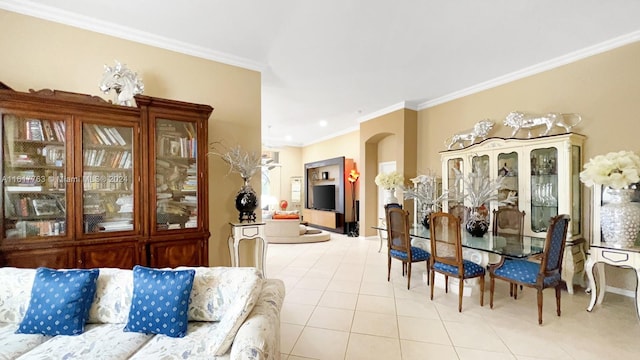 dining space featuring light tile patterned floors and crown molding