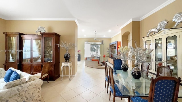 tiled dining area featuring crown molding