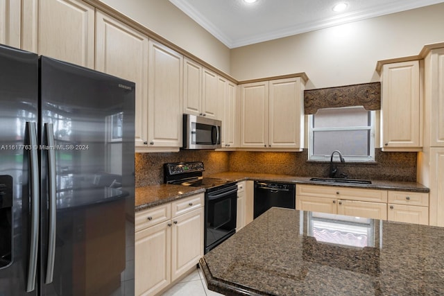 kitchen with black appliances, dark stone countertops, sink, and tasteful backsplash