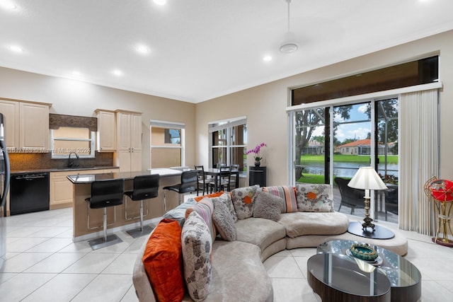 tiled living room with ornamental molding and sink