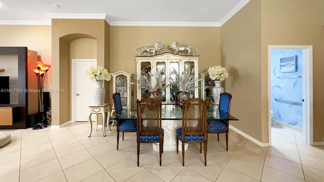 dining area featuring light tile patterned floors and crown molding