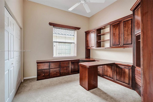 unfurnished office with ceiling fan and light colored carpet