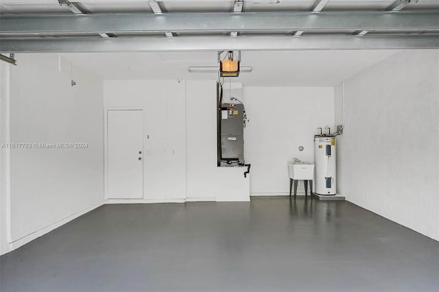 garage featuring electric water heater, heating unit, a garage door opener, and sink