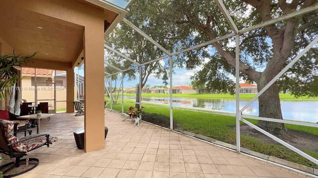 unfurnished sunroom featuring a water view