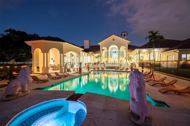 view of pool featuring a hot tub and a patio area