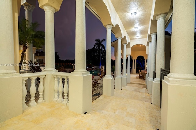 corridor featuring decorative columns